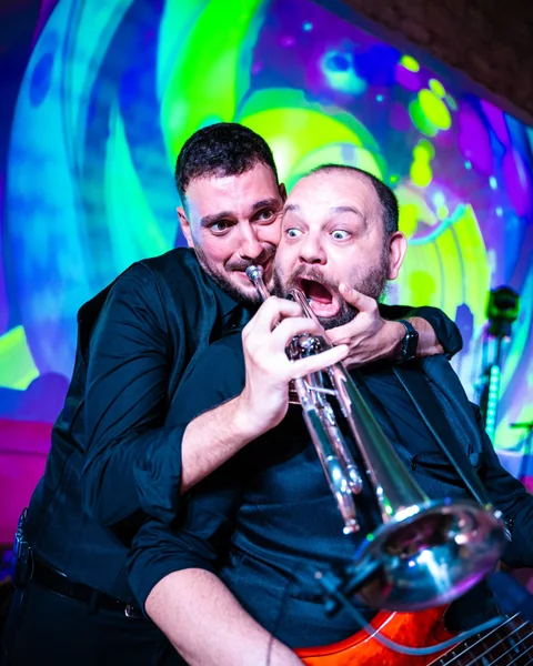 The Gloves trumpet player and bassist sharing a playful moment